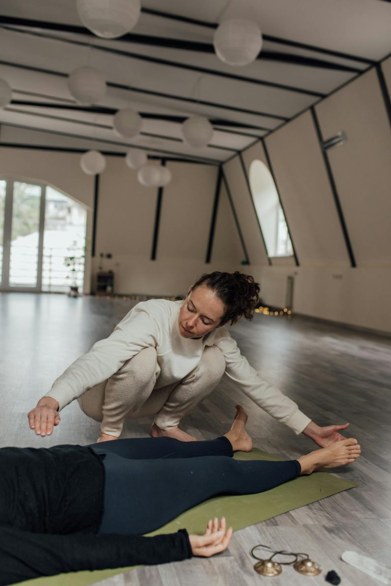 A woman in a modern studio receives therapeutic guidance, fostering relaxation and well-being.
